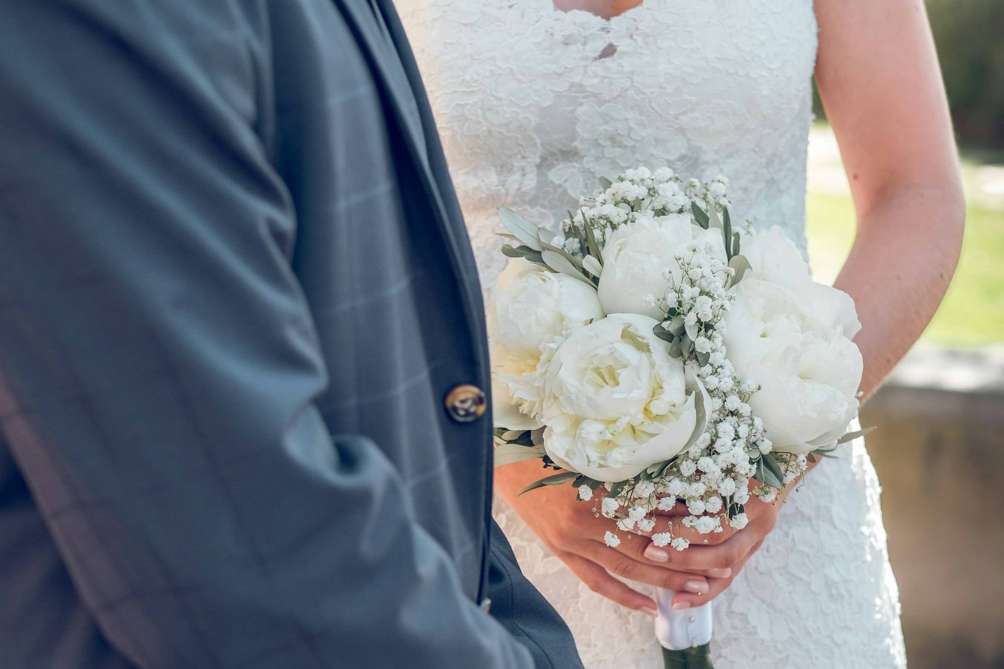 Married couple in wedding clothes holding hands